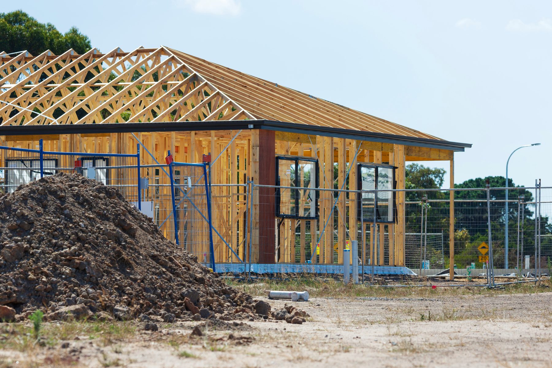 A timber-framed Australian home under construction on a residential block at midday — the kind of trade business Tradie Office Pro is built for.